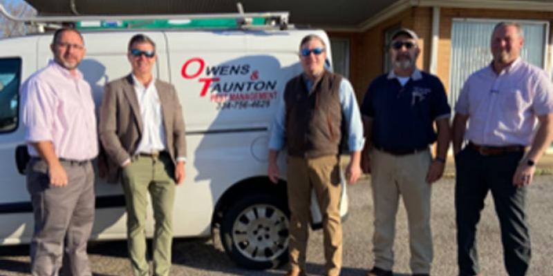 knox pest control staff stand next to a company van